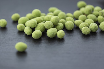 Snack, peanuts in the coating of wasabi. Close up