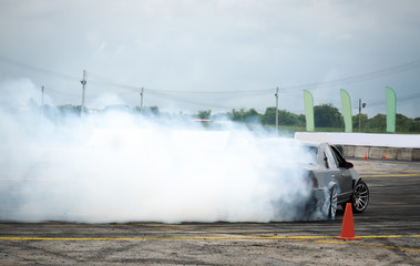 Car drifting on track with grain, Sport car wheel drifting and smoking on track.