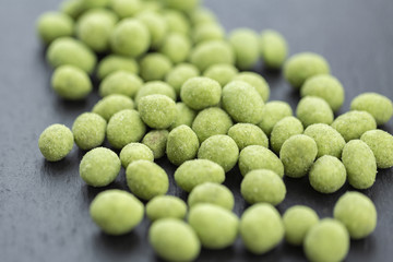 Snack, peanuts in the coating of wasabi. Close up