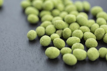 Snack, peanuts in the coating of wasabi. Close up