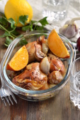 Baked in the oven chicken with orange, garlic and onion