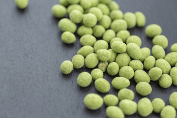 Snack, peanuts in the coating of wasabi. Close up