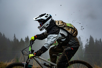 Professional Cyclist Riding the Mountain Bike Down the Rocky Hill. Extreme Sport and Enduro Biking...