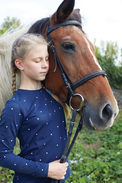 Portrait of young horsewoman and brown horse. Girl with horse.