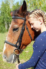 Portrait of young horsewoman and brown horse. Girl with horse.