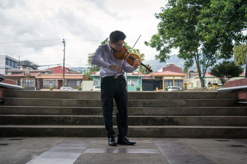 man playing violin in the square