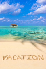 Fototapeta premium Word Vacation on beach