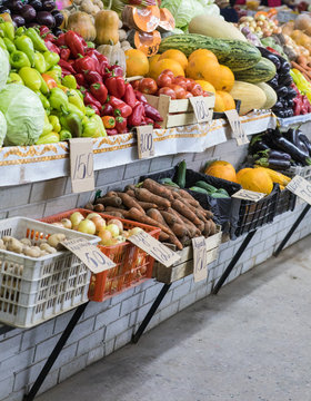 Assortment of fresh vegetables at market counter, vegetable shop