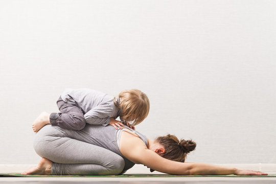 woman mom practicing yoga with her child