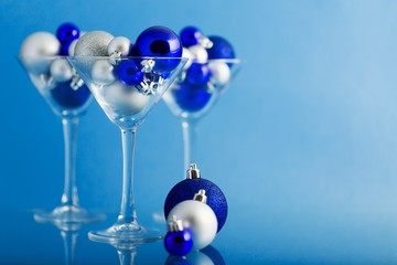 Christmas Baubles in a Martini Glasses on the Blue Background