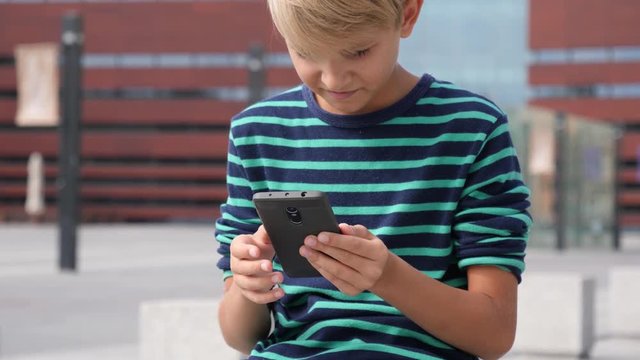 Type slide smartphone in social media page kid boy sit in public city center place
