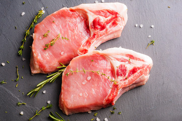 Fresh pork steaks on the slate board
