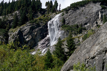 Waterfall at a pass road in Austria in early autumn 
