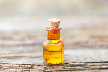 Essence of flowers on table in beautiful glass jar