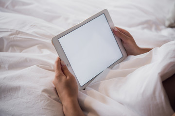 Close up of a woman hands holding a tablet showing a blank screen at home