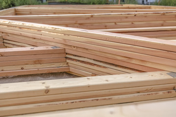 Stacked segments of rooftop construction on ground