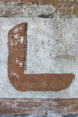 painted letter on old wall