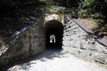 The girl enters the tunnel. Tunnel under the railway.