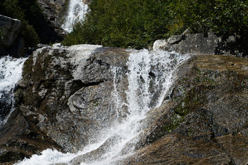Waterfall at a pass road in Austria in early autumn 
