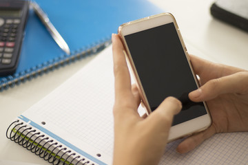 Woman using a smartphone with black screen