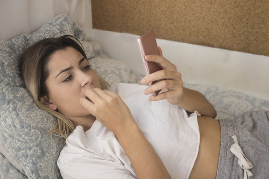 Nervous woman reading telephone message