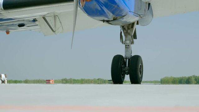 Medium shot of landing gear of passenger aircraft located at the airport. 4K