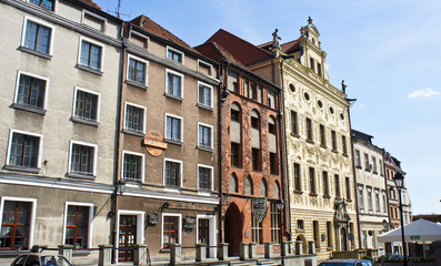 Fototapeta na wymiar Torun, Poland - 04/19/2014 - street in old town with colorful buildings, sunny day