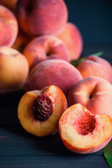 Ripe and tasty peaches on a wooden table