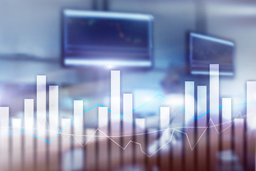 Financial graphs and charts on blurred business center background. Invesment and trading concept.