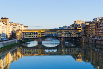 Obraz premium Famous bridge Ponte Vecchio over Arno river at sunset in Florence, Tuscany, Italy