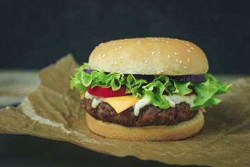 Delicious fresh homemade burger on a wooden table