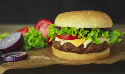 Delicious fresh homemade burger on a wooden table