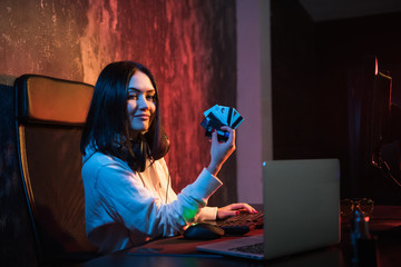 Smiling young rubber in sweatshirt with hood making purchases in internet and paying with stolen credit card