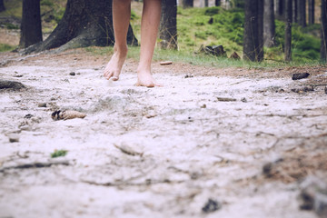 barefoot child walk alone by path, explore the forest. Outdoor hiking activities.