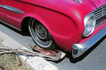 A view of a purple vintage classic American car in the street 