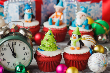 Christmas cupcakes with colored decorations, soft focus background