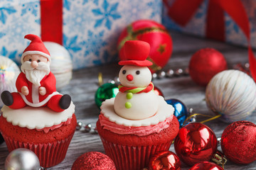 Christmas cupcakes with colored decorations, soft focus background