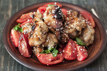 Grilled chicken wings with sesame seeds on a plate