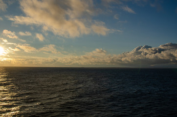 Blue sky over blue Baltic sea with clouds.