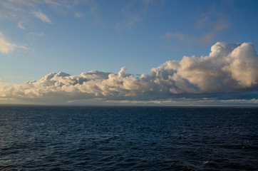 Obraz premium Blue sky over blue Baltic sea with clouds.