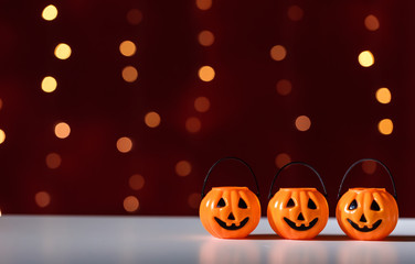 Halloween pumpkins on a shiny light dark red background
