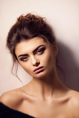 Naklejka premium Portrait of beautiful young brunette woman with makeup