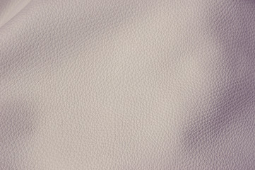 Artificial leather of beige color, toned image