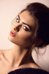 Obraz premium Portrait of beautiful young brunette woman with makeup