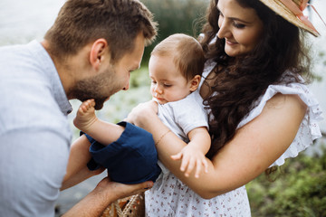 Mother father and little son in the summer park