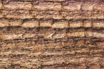 The texture of the rock surface with horizontal lines. Stone background
