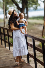 Fototapeta premium Amazing young mother with little son in the park 
