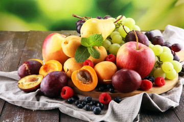 Fototapeta na wymiar Fresh summer fruits with apple, grapes, berries, pear and apricot