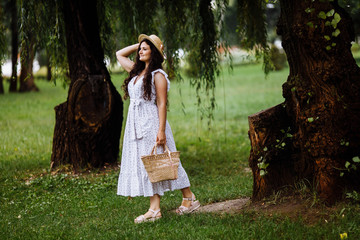 Pretty young lady with hat in the park