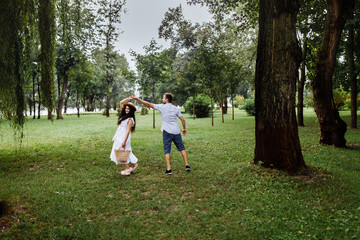 Pretty couple in the forest at summer 